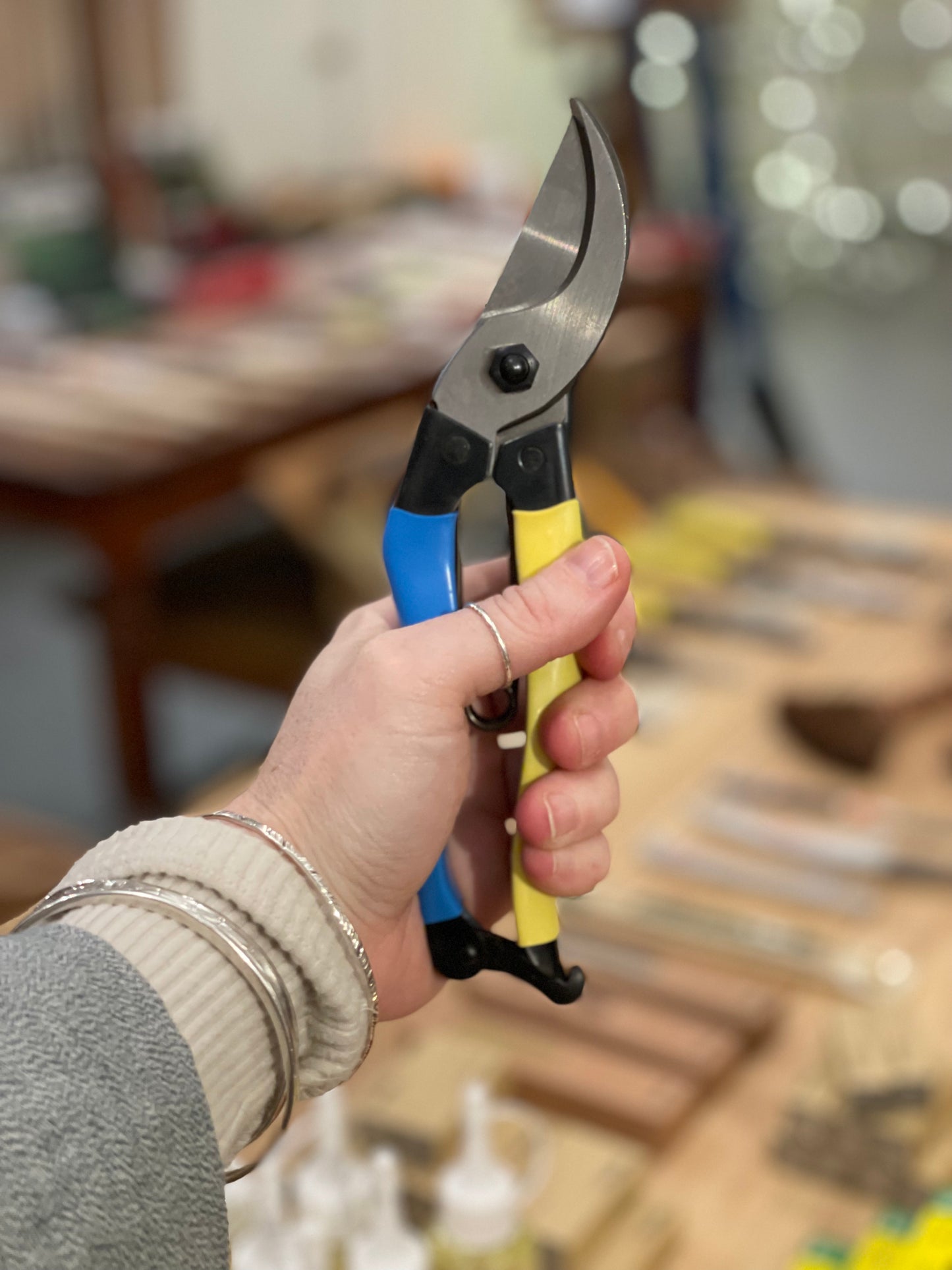 Pair of Niwaki Mainichi Left Handed secateurs being held in someones hand