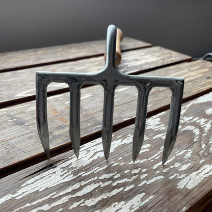 Sneeboer Cherry Hand Rake displayed on wooden crate