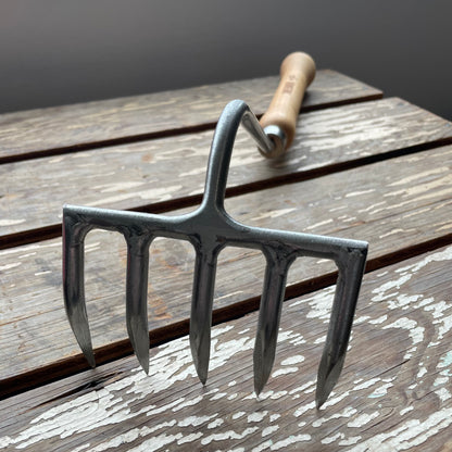 Sneeboer Cherry Hand Rake displayed on wooden crate