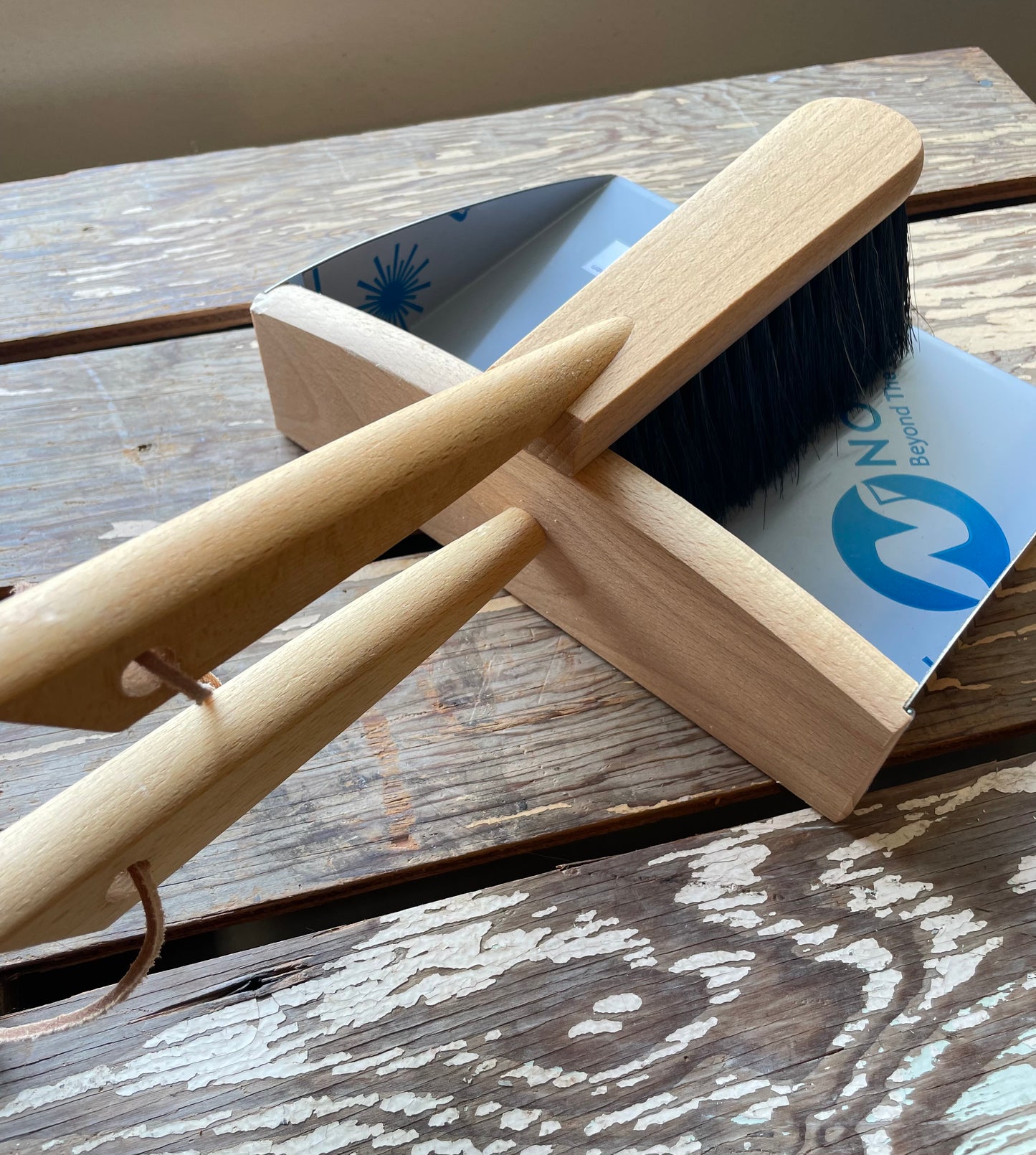Redecker Hand Brush & Dustpan set for cleaning and sweeping pictured on wooden crate