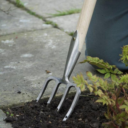 Sneeboer Great Dixter Short Fork being used in garden bed