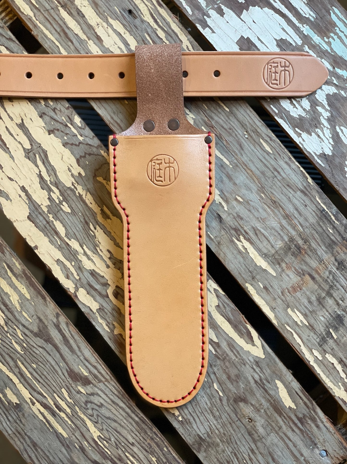 Tan leather Niwaki long holster with copper rivets, designed to hold long-bladed topiary clippers or a Hori Hori knife pictured with Niwaki Leather Belt