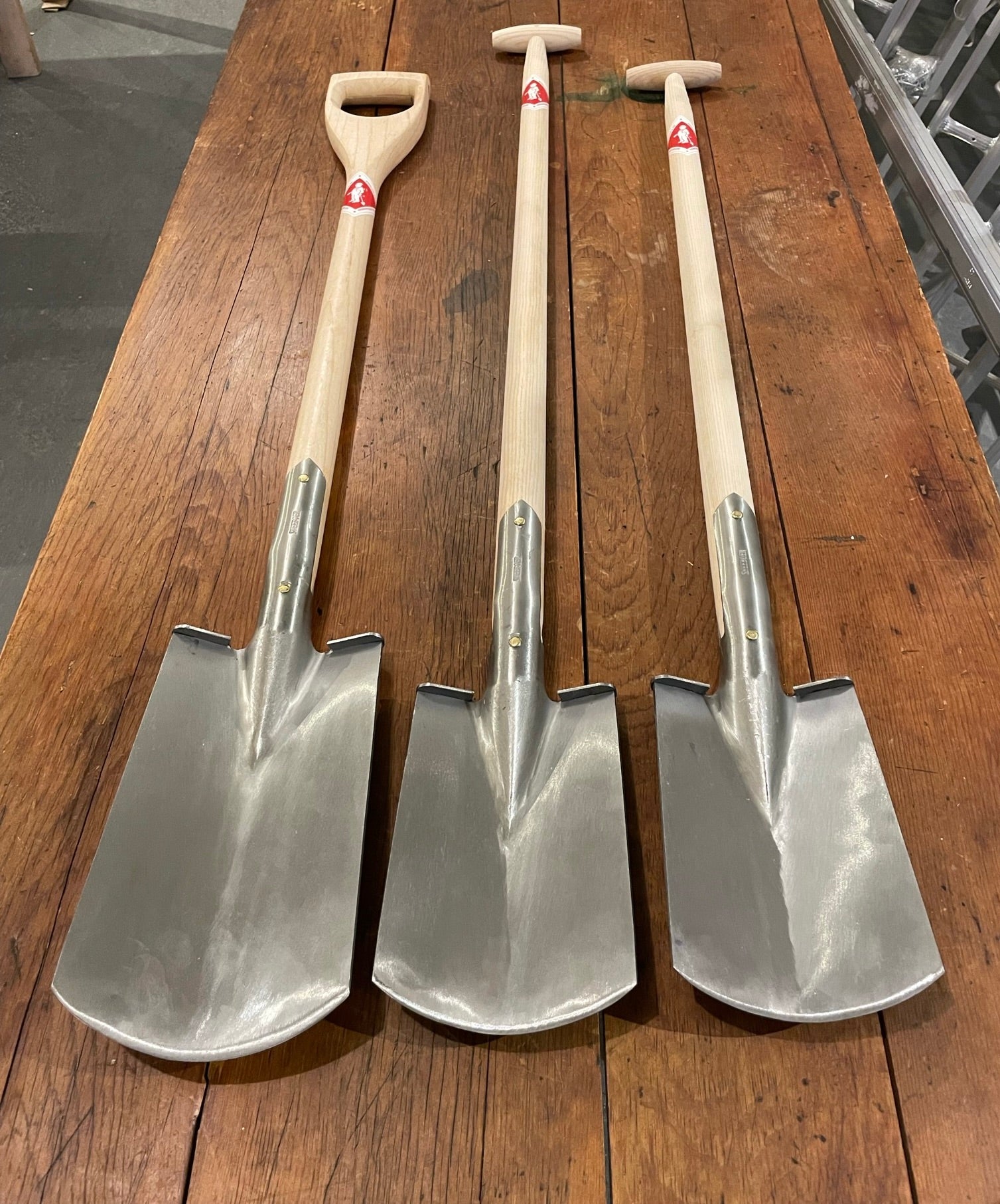 Sneeboer Border Spade Standard, Tall & Sneeboer D-Handle Spade pictured on wooden table